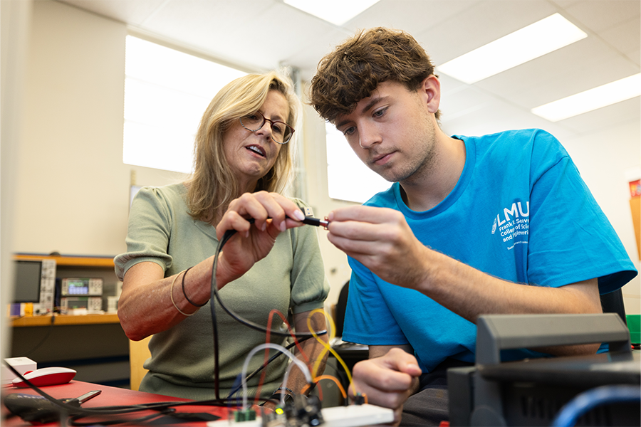 Electrical engineering student in lab with professor Marino